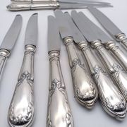 Set of 12 sfam knives in silver metal and stainless steel blades.