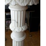 Saddle column in fluted white marble with floral motifs.