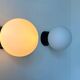 Pair of vintage Raak opaline and Bakelite wall lights, Netherlands 1970s