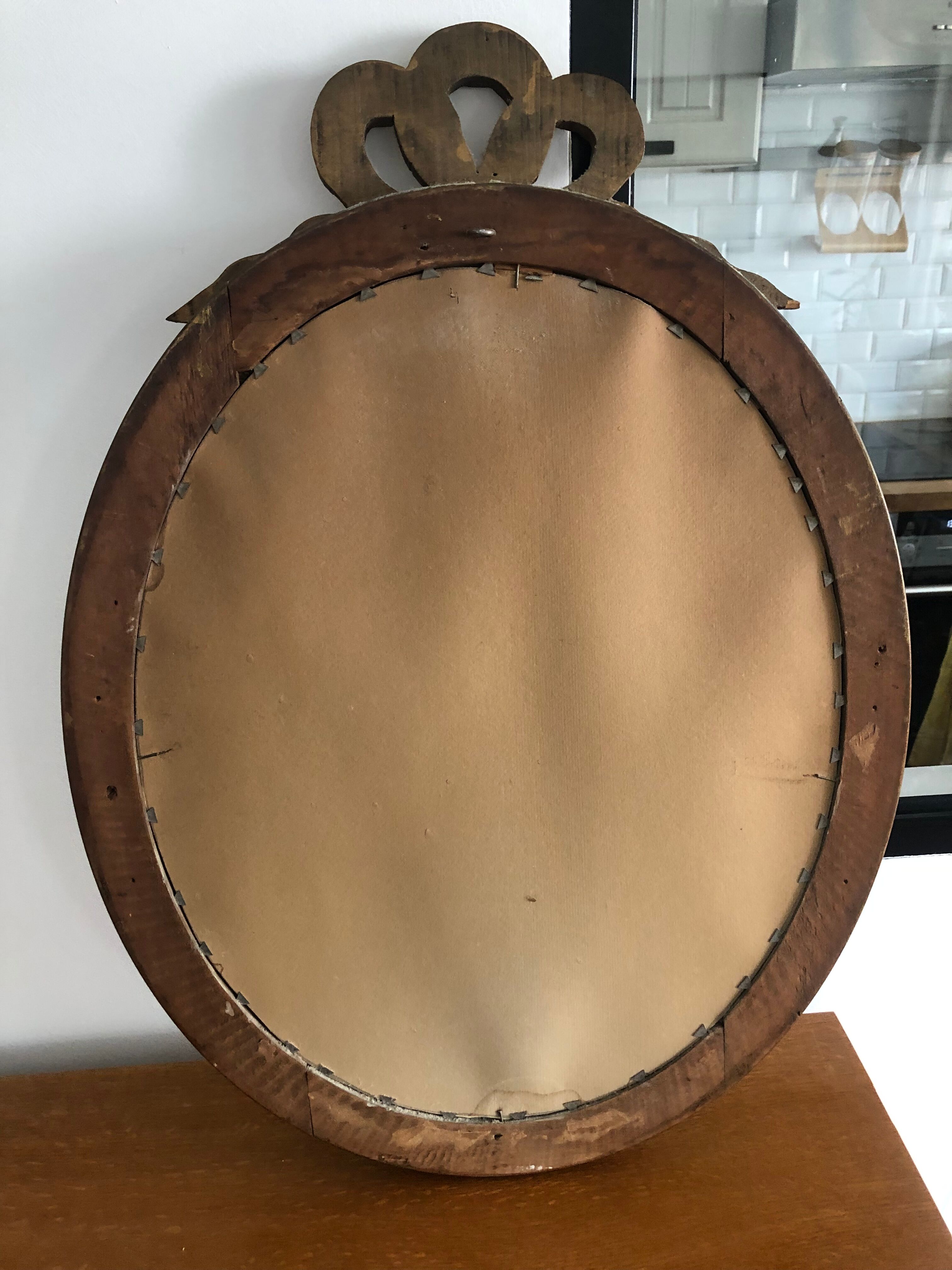 Old oval mirror with a pediment