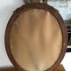Old oval mirror with a pediment