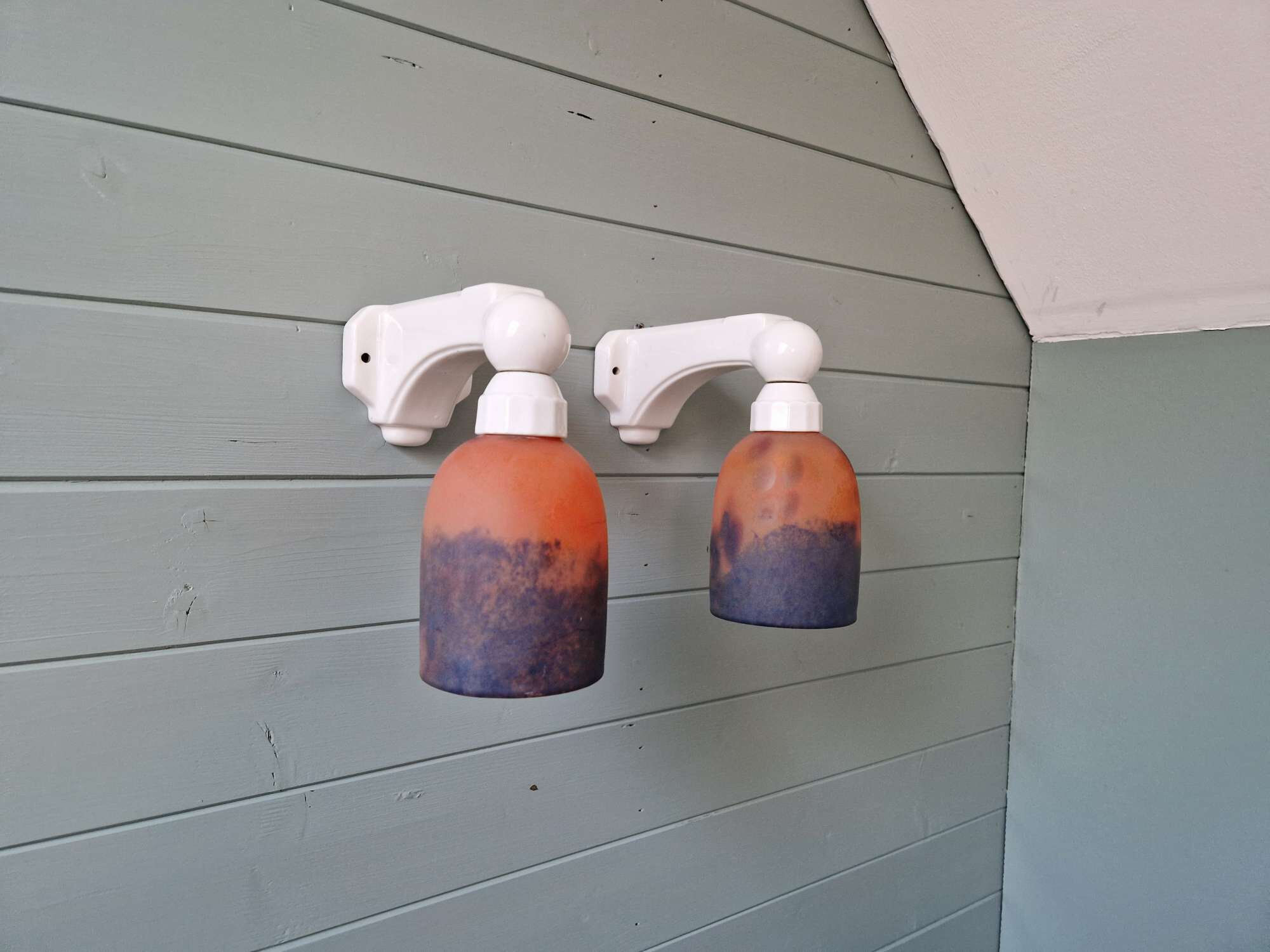 Pair of Art Deco wall sconces in multicoloured porcelain and frosted glass.