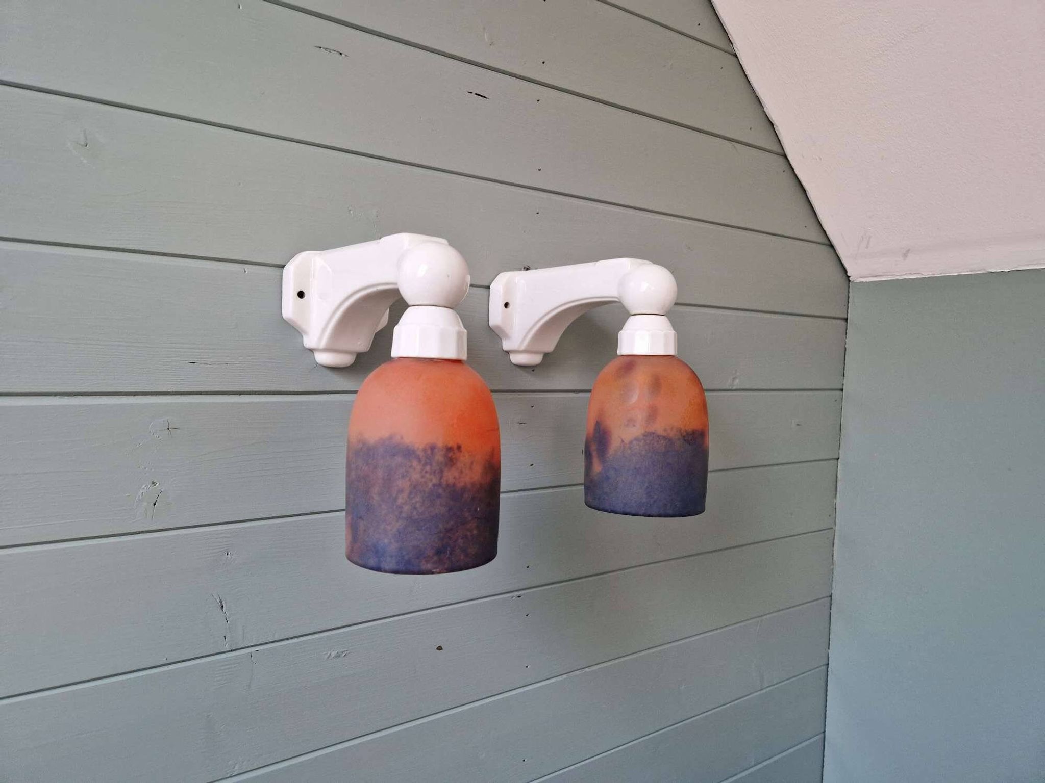 Pair of Art Deco wall sconces in multicoloured porcelain and frosted glass.