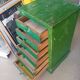 Vintage workshop furniture with 6 green drawers.