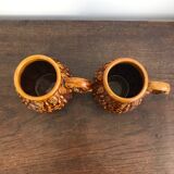 Set of 2 vintage caramel-colored slip mugs with flower pattern