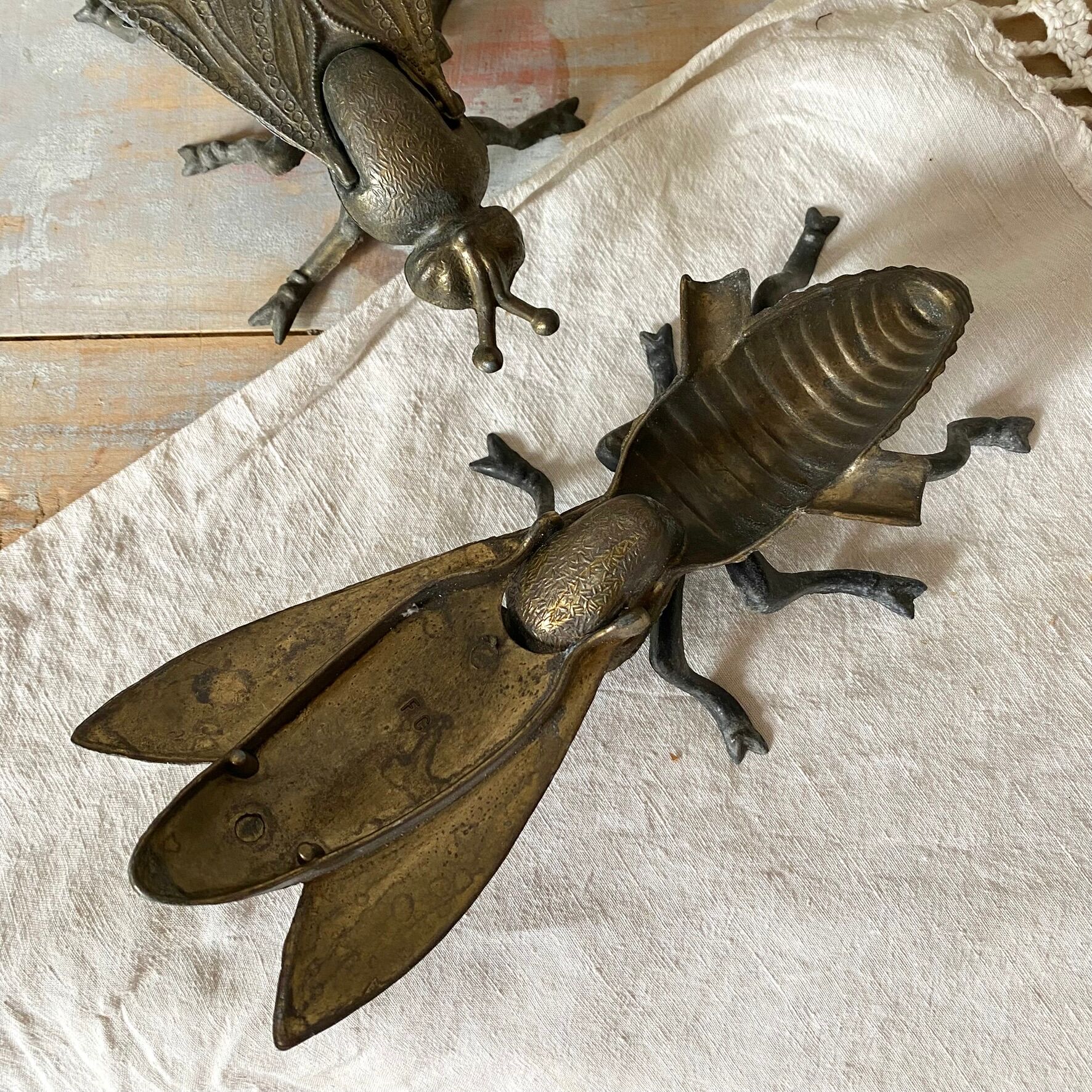 2 metal ashtrays with insect fly designs from the 1950s-60s.