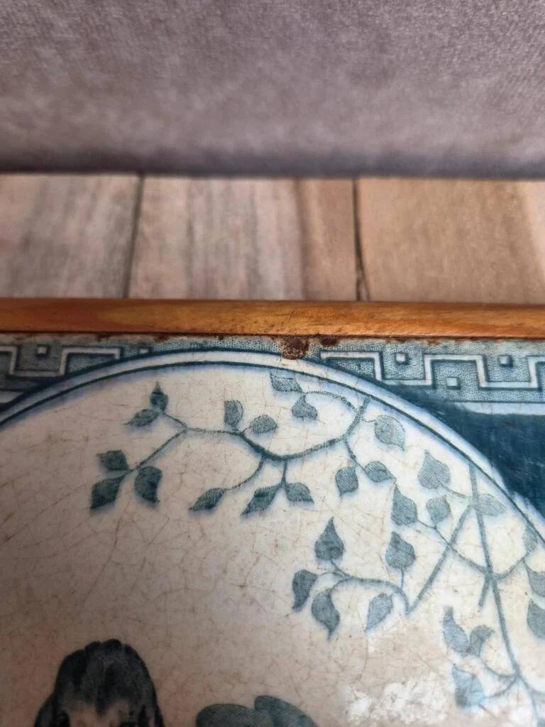 Antique trivet in Gien tile with blue bird decoration – wooden border