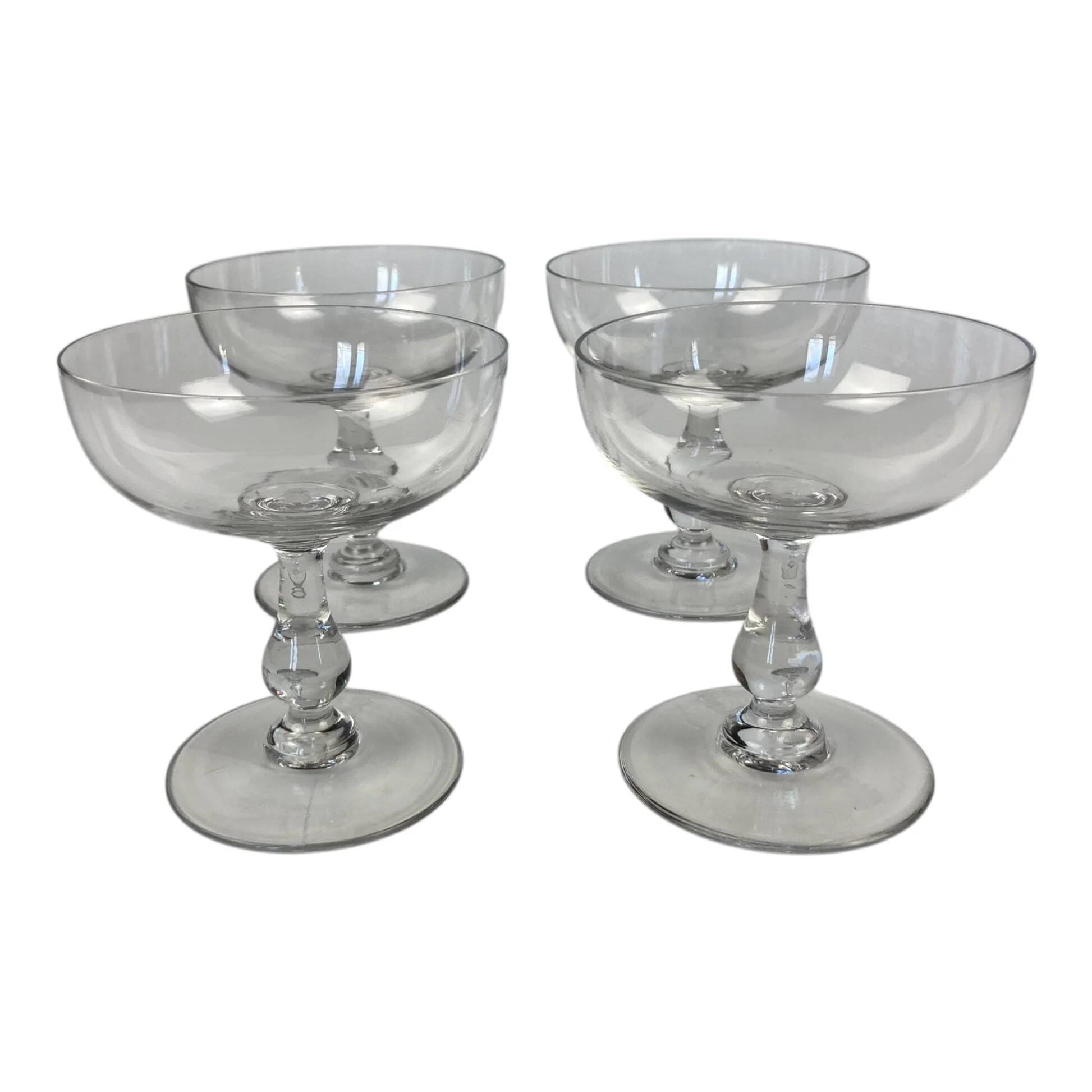 4 Baccarat crystal champagne coupes in a gondola shape.