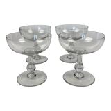4 Baccarat crystal champagne coupes in a gondola shape.