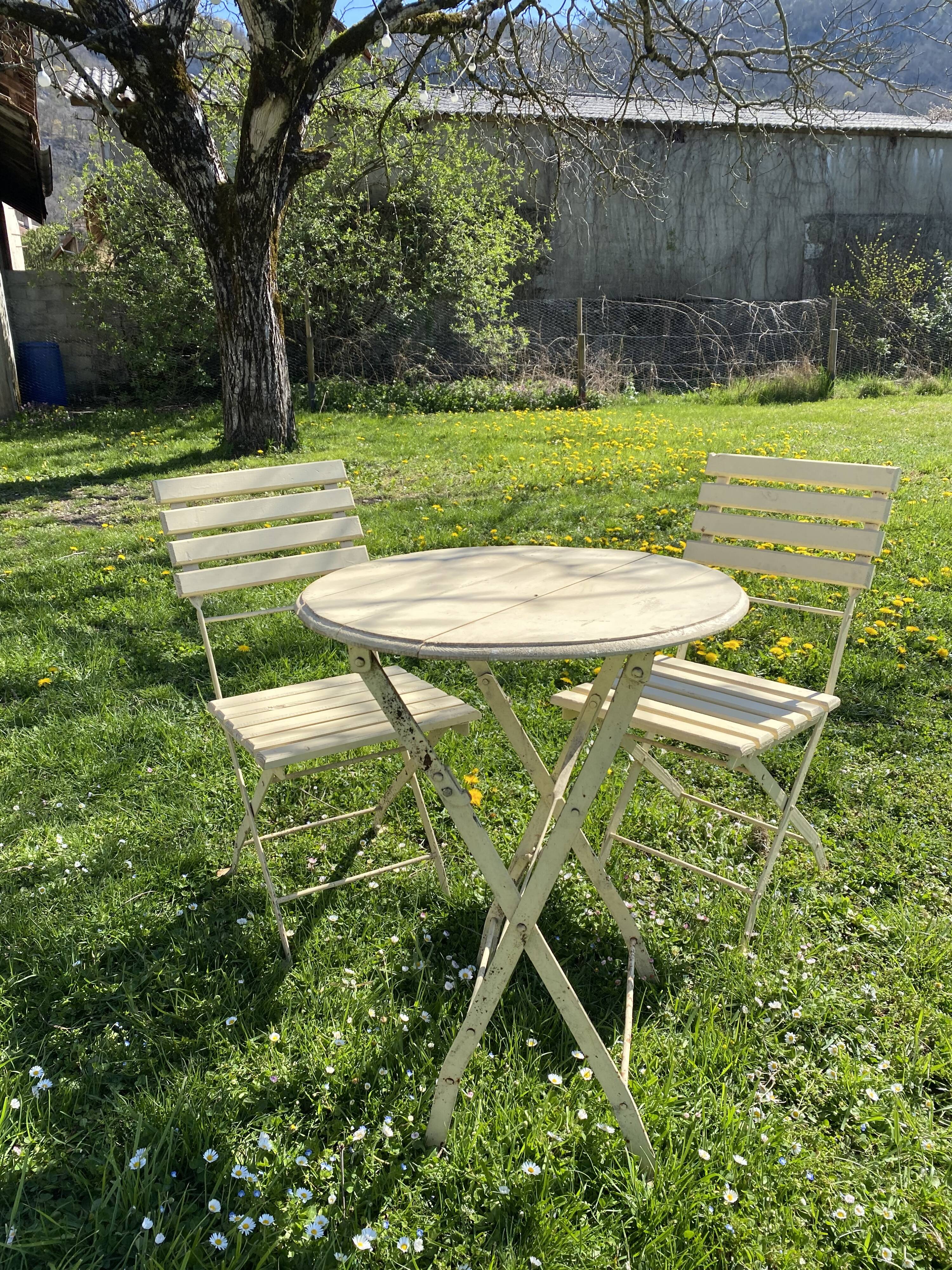 Table et 2 chaises de jardin en métal et bois beige marquées "Bistrot Paris"
