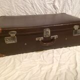 Suitcase vintage leather inside and brown carpeted home