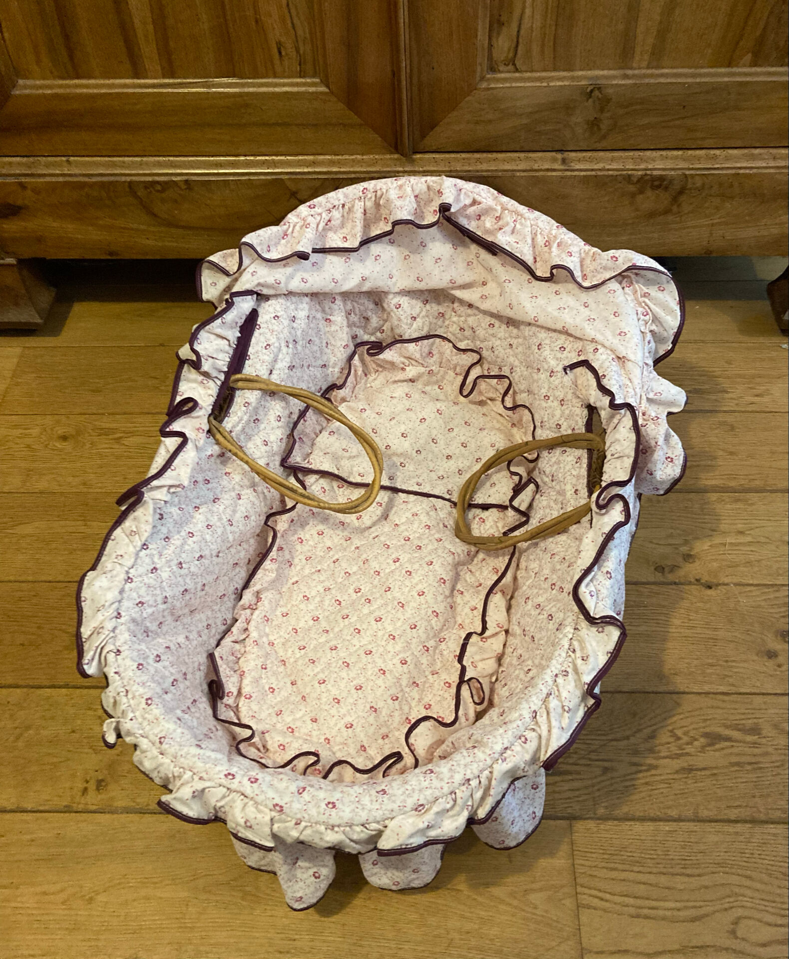 1960s wicker cradle with mattress and drapes.