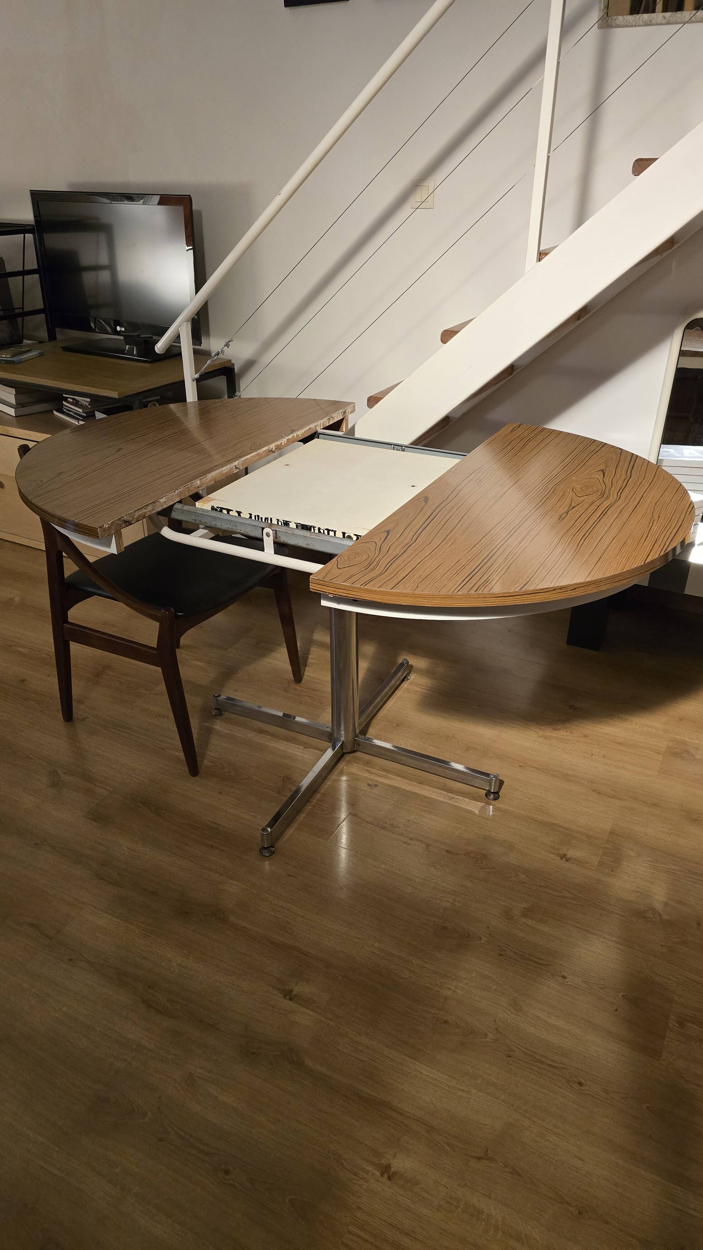 Extendable round table with a space age vintage mid-century formica top.