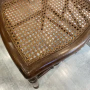 Pair of antique caned and wooden chairs from the 1900s.