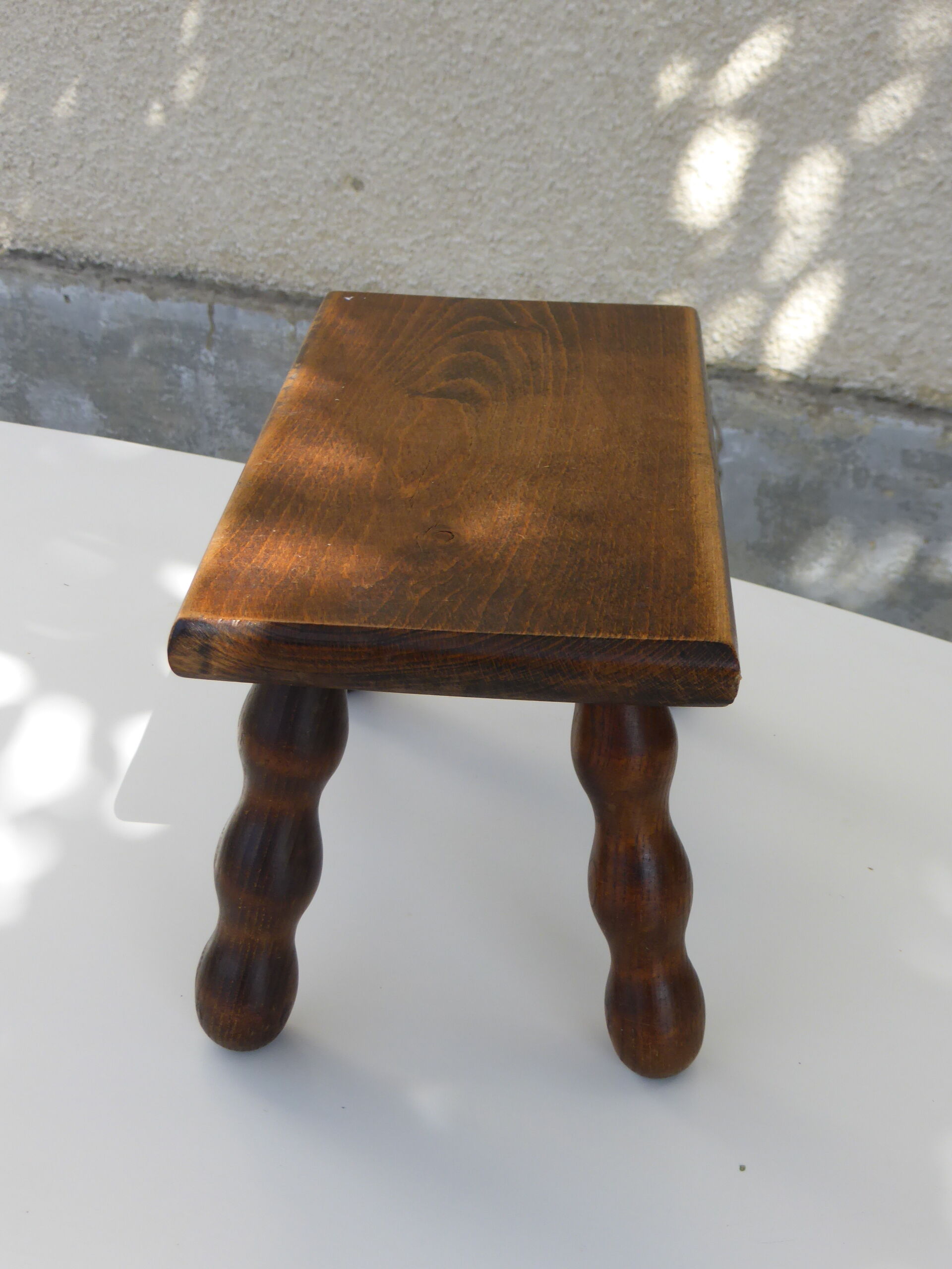 Old wooden stool, worked, turned foot, handcrafted