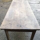 Antique farmhouse table in solid oak with tapered legs and 1 drawer at the end.