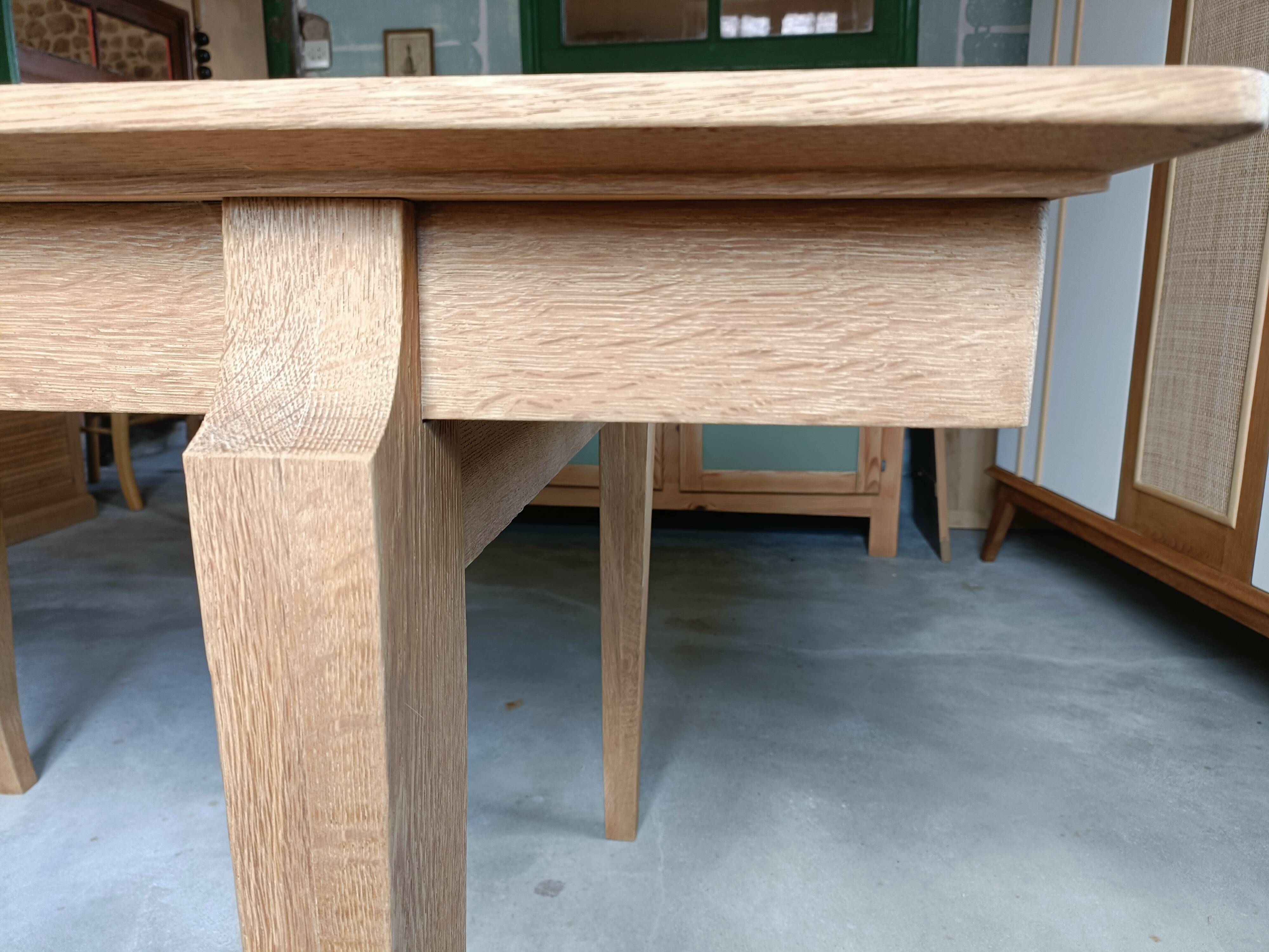 Oak dining table with a checkerboard top and extensions.