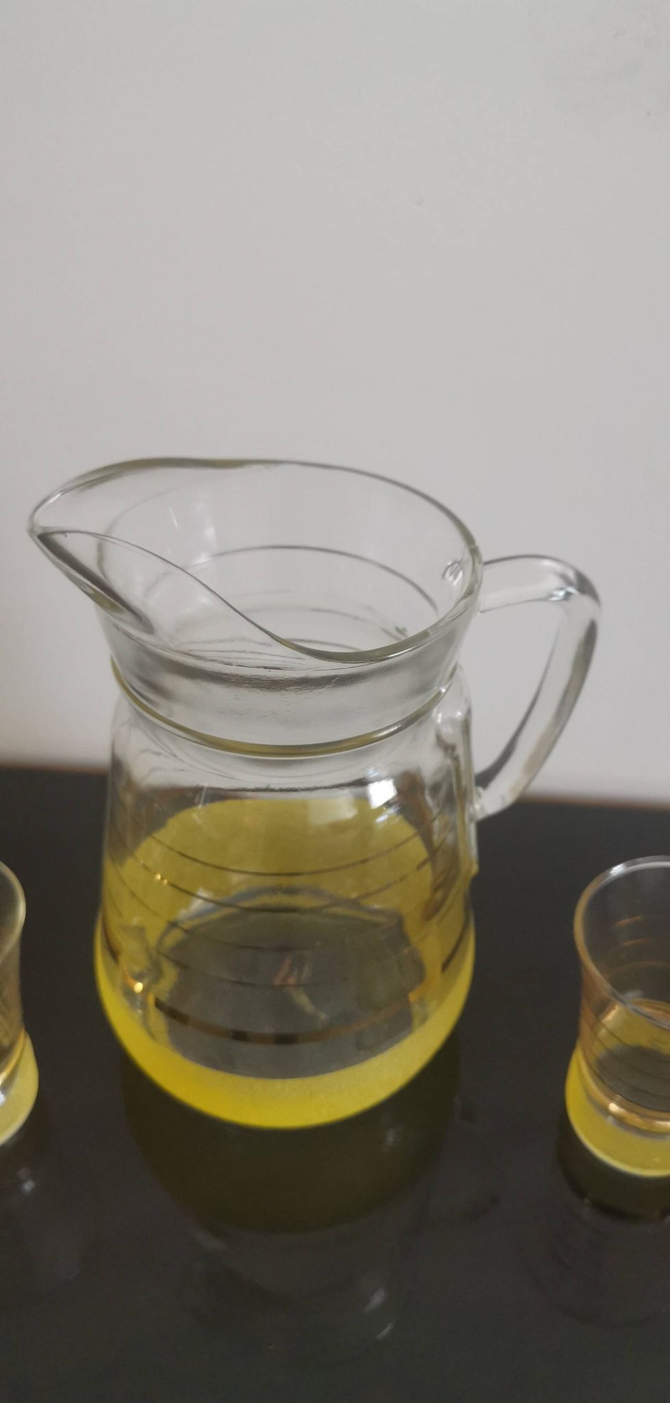 Old pitcher with its 8 yellow granite glasses with gold edging vintage 50's