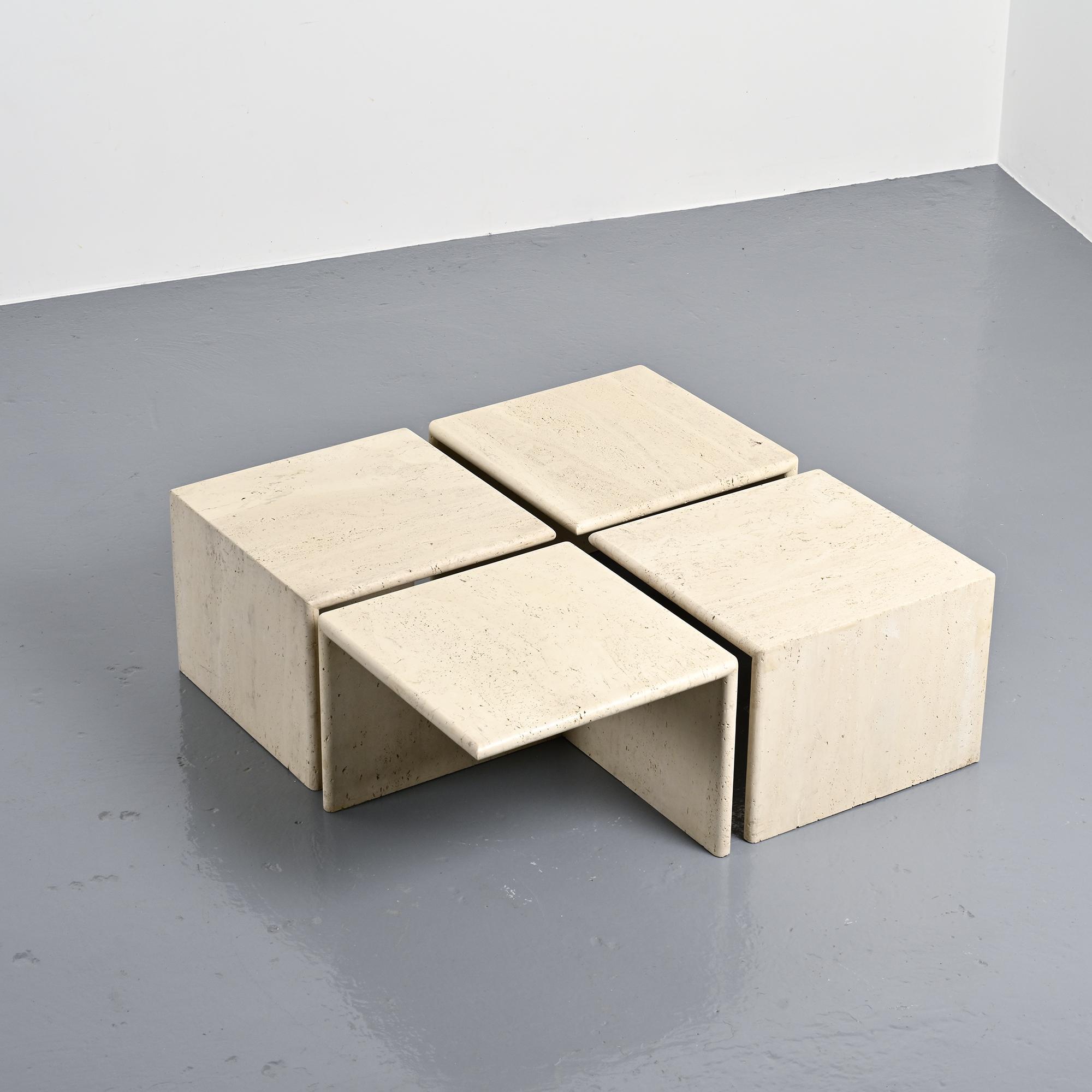 Set of four side tables in travertine, Italy, 1970s.
