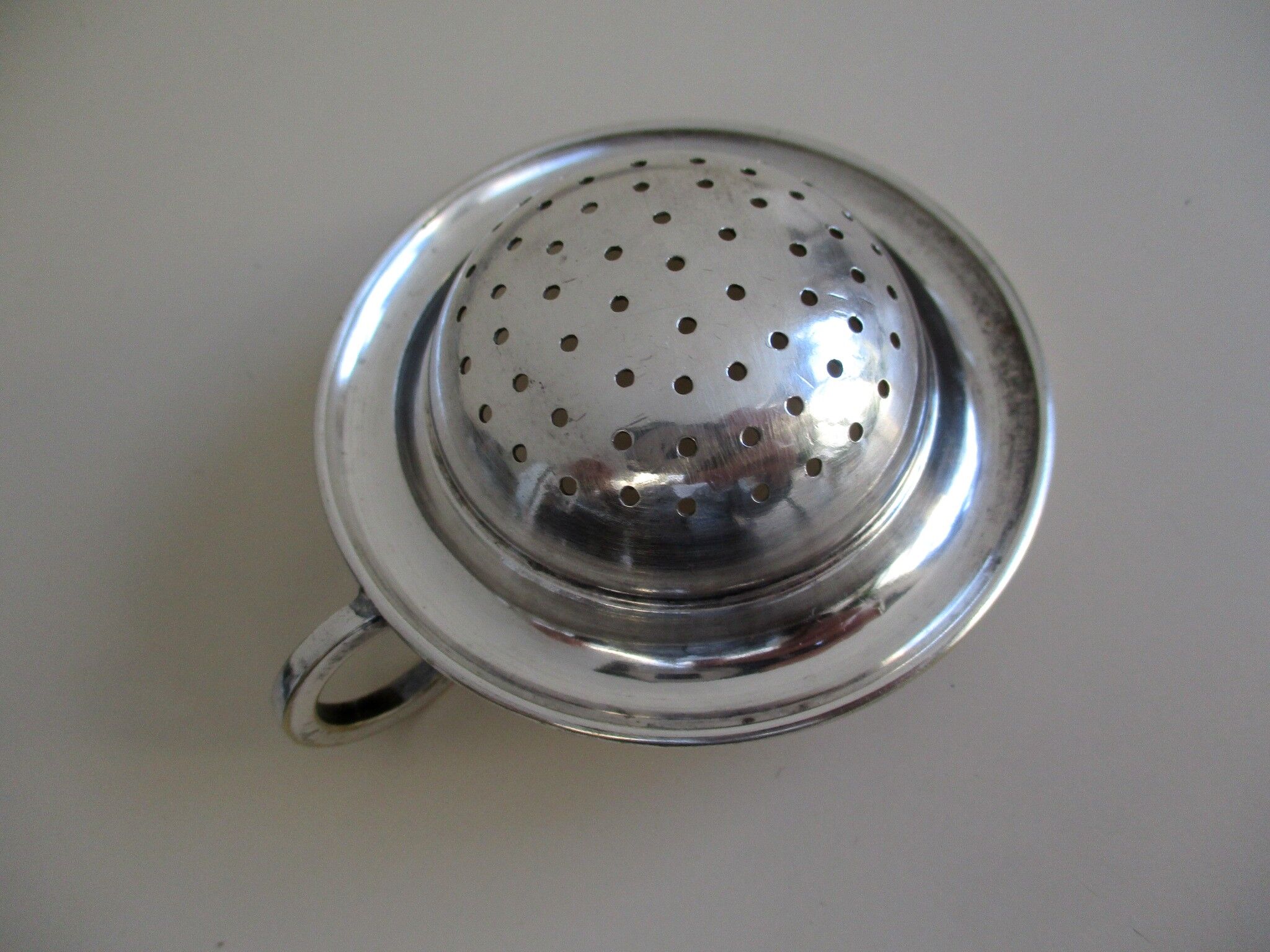 Silver metal tea strainer