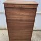 Oak two-column filing cabinet with curtains.