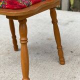2 curved wood and red fabric chairs