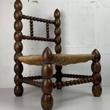 Brutalist wood turned bobbin low rush chair in the style of Charles Dudouyt