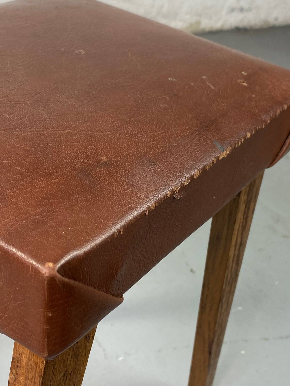 Small stool or footrest in wood and leather