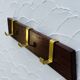 Vintage wooden and brass coat rack with 3 hooks from the 1960s.