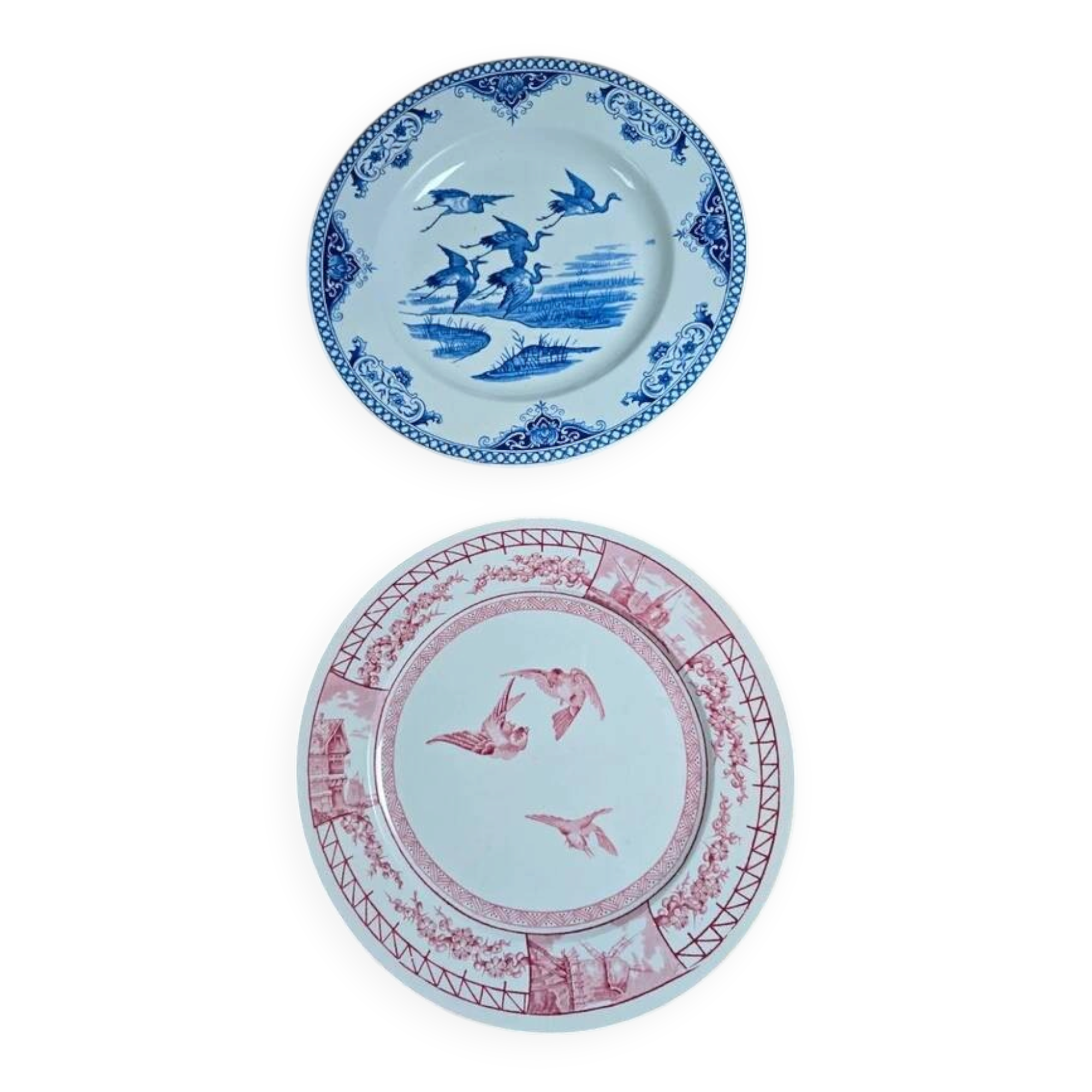 A pair of old flat plates with red and blue bird patterns.