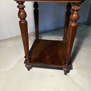 Antique wooden bedside table with turned legs.