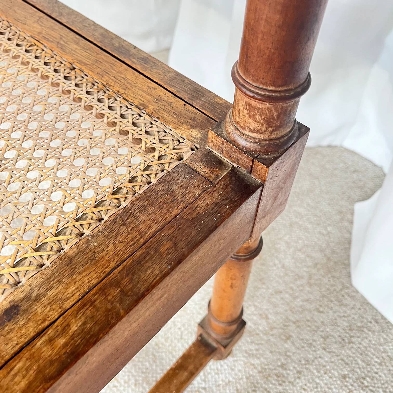 Antique banquette in Louis XIII style, turned wood with caning, late 19th to early 20th century.