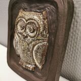 Small relief with a motif of an owl emerging from the back plate.