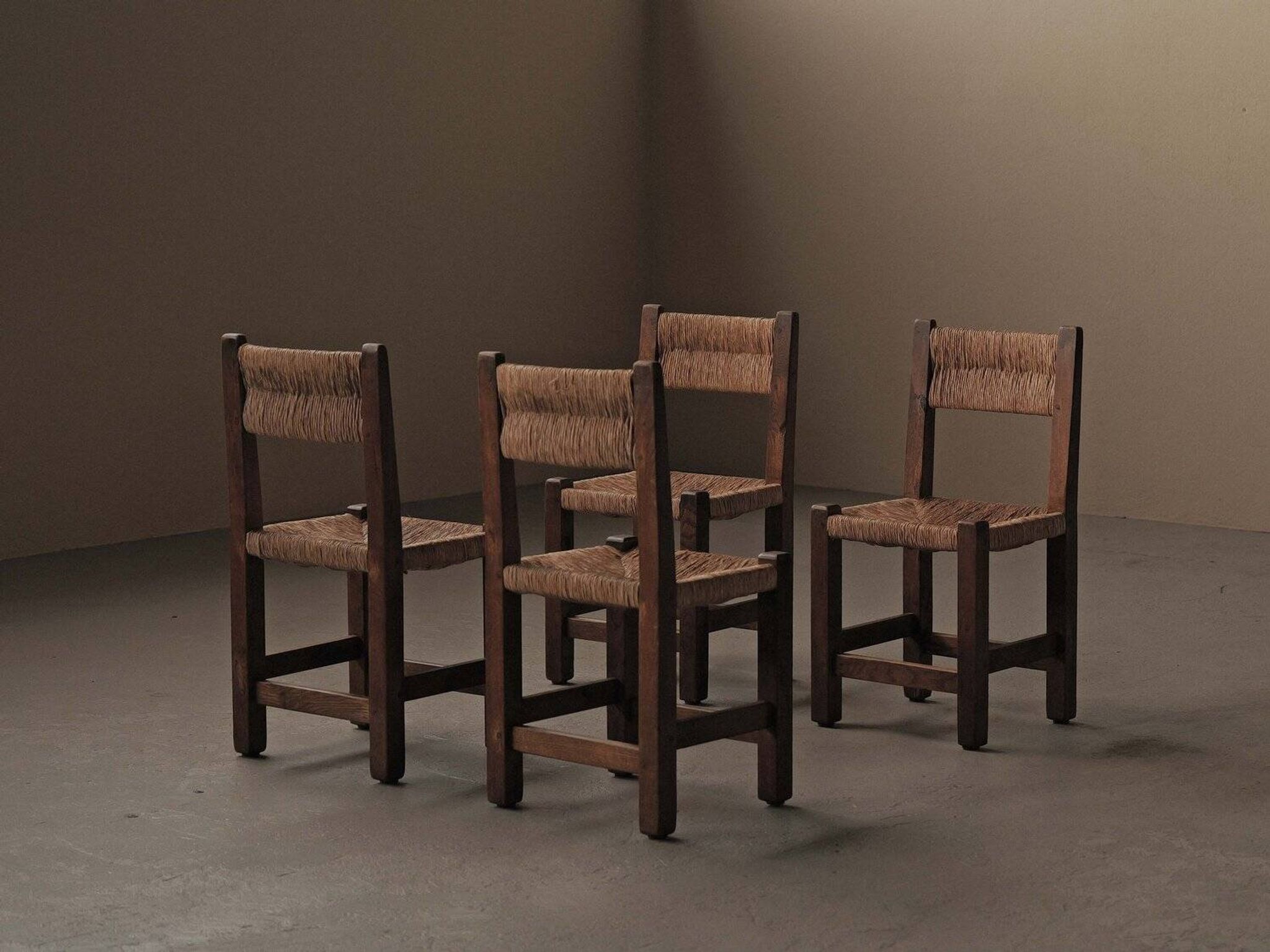 Set of four modernist chairs in oak and straw, France, circa 1960.