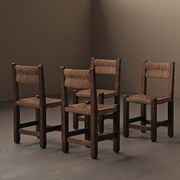 Set of four modernist chairs in oak and straw, France, circa 1960.