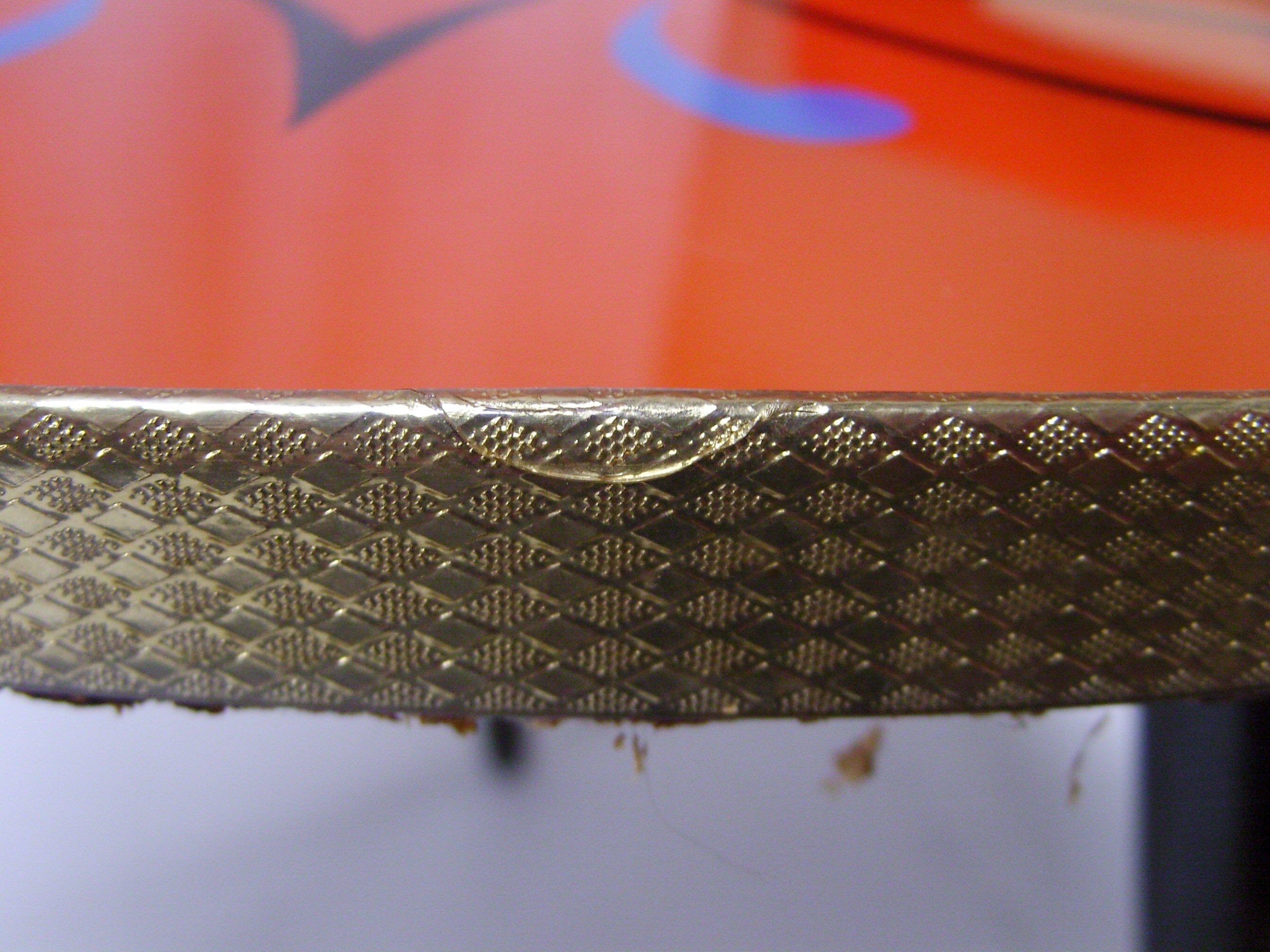 Plant holder tripod in geometrically patterned orange formica