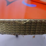 Plant holder tripod in geometrically patterned orange formica