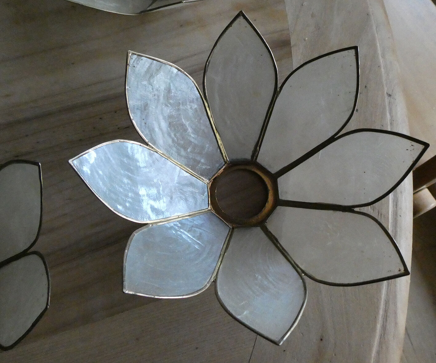 Brass chandelier and flowers in mother-of-pearl petals