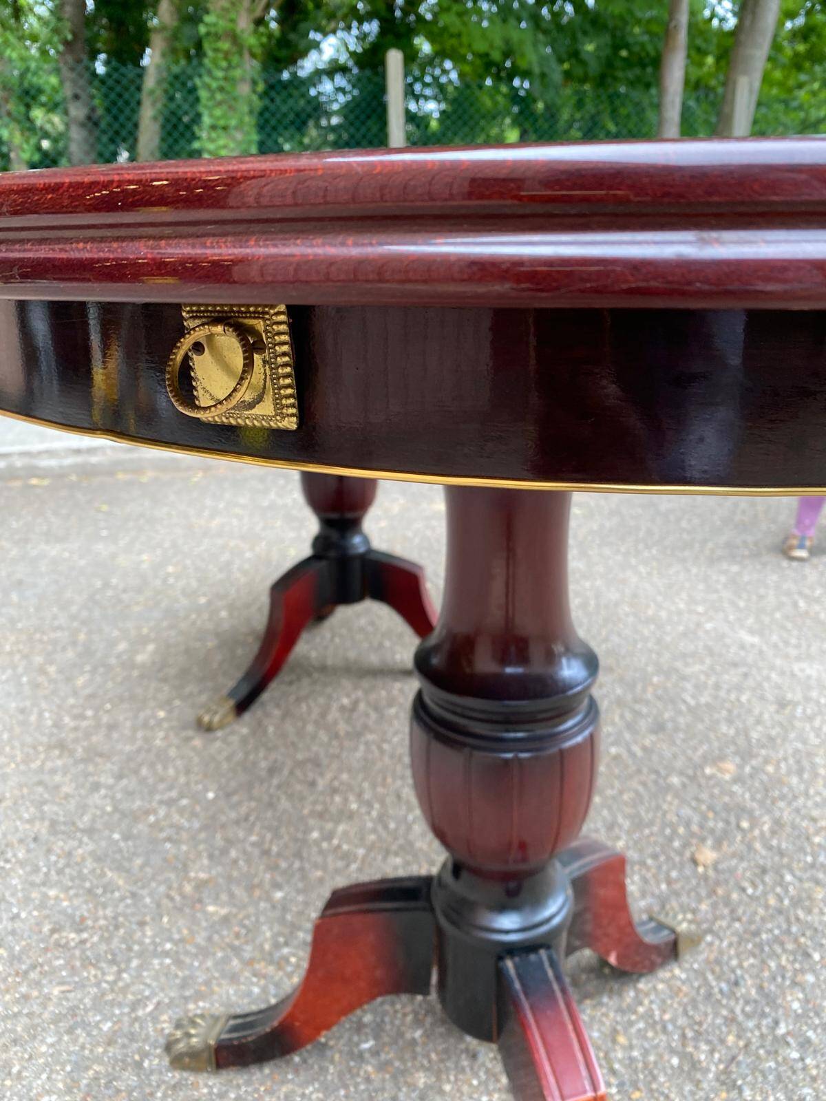 Glossy mahogany dining table in English Regency style from the 1970s.
