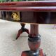 Glossy mahogany dining table in English Regency style from the 1970s.