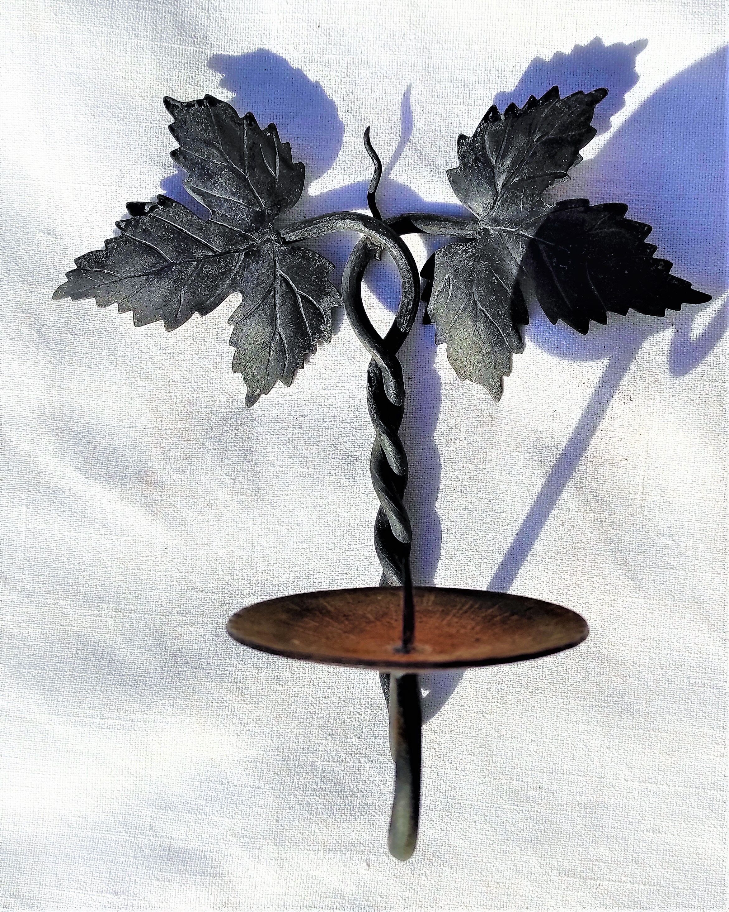 Wrought iron wall candle lamp with ancient vine leaves