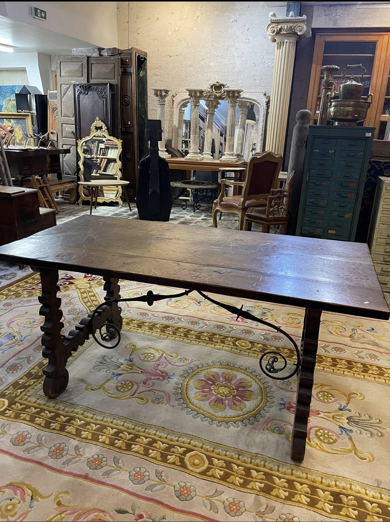 Spanish table in walnut and wrought iron, lyre-shaped base.