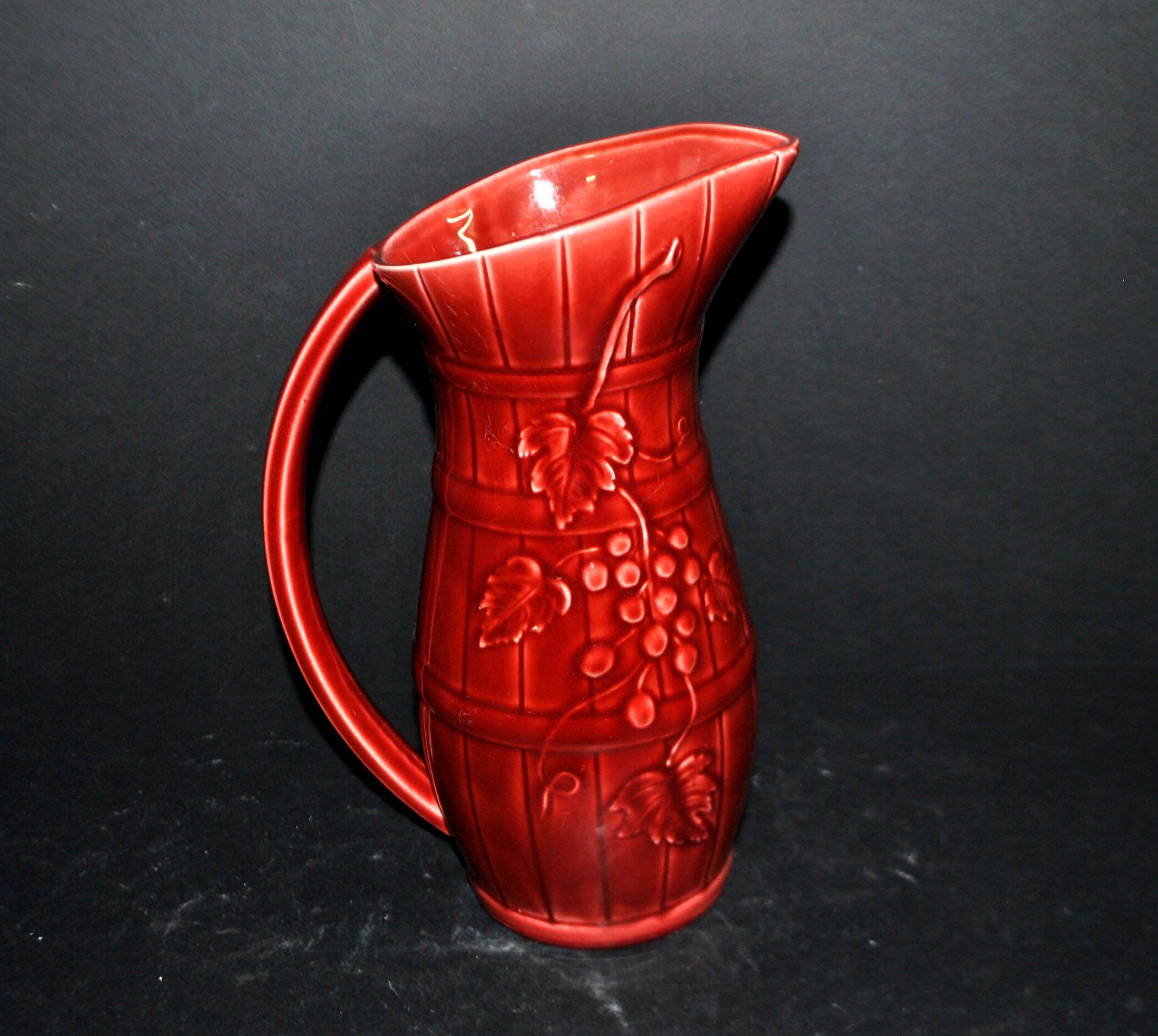 Sarreguemines wine jug in red slipware with grapevine decoration.