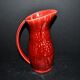 Sarreguemines wine jug in red slipware with grapevine decoration.
