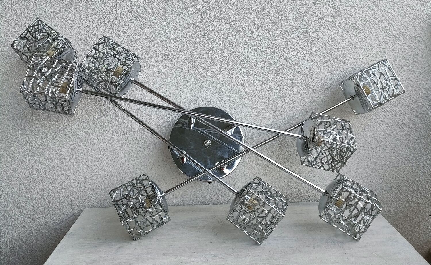 Articulated chromed metal luminaire