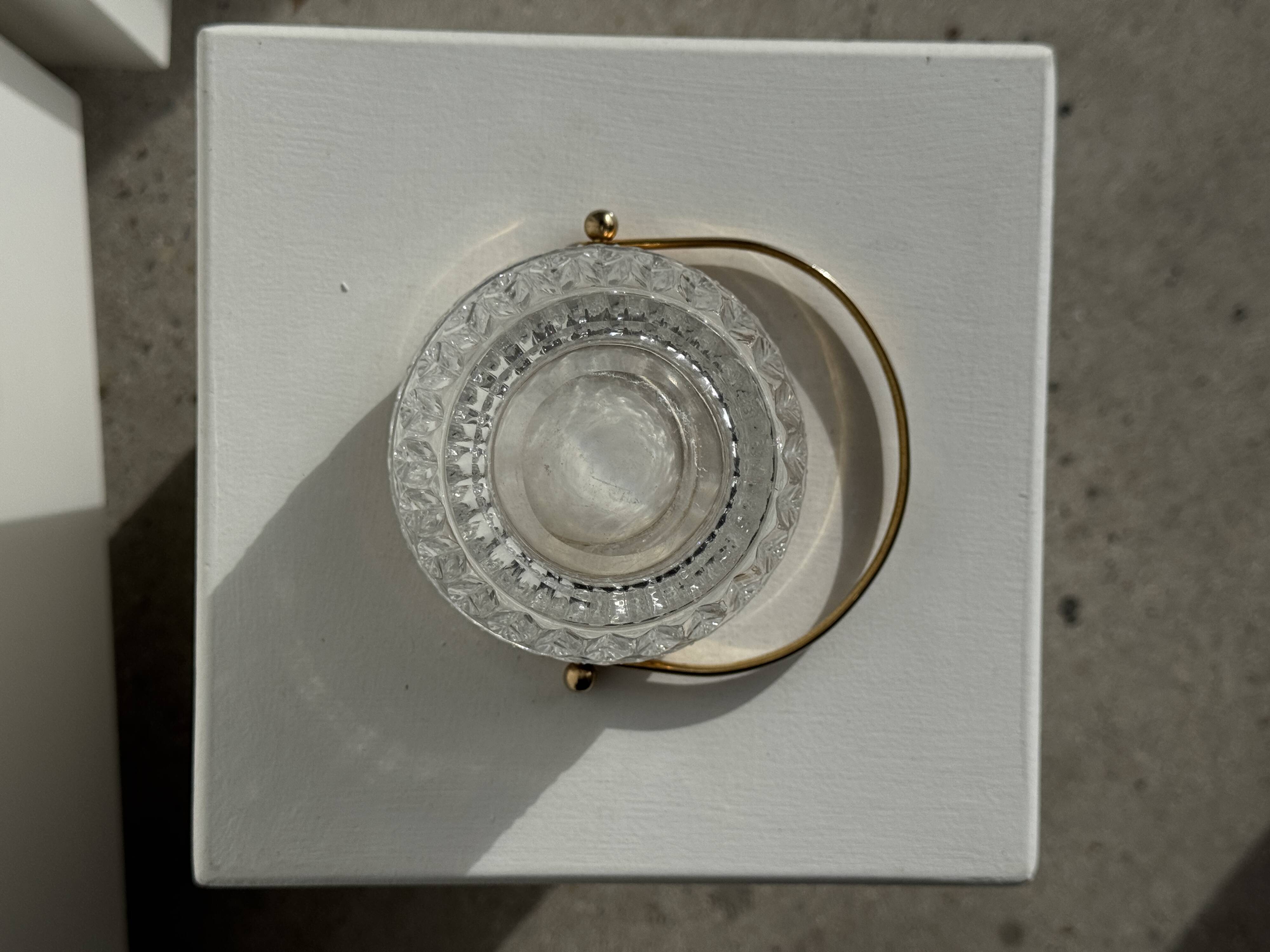 Small golden glass ice bucket with diamond point design and its scoop.