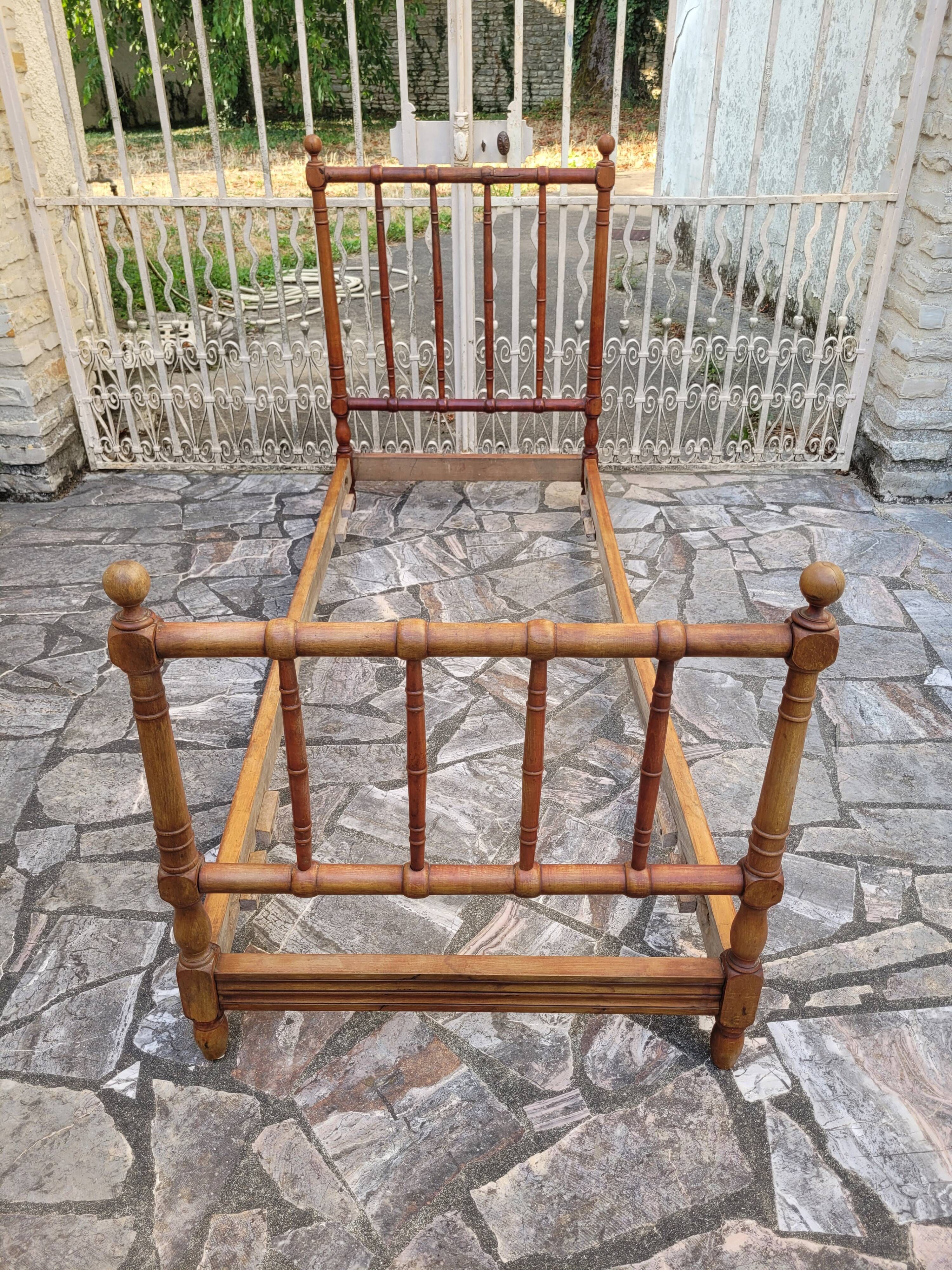 Child's bed or vintage rest bed made of solid cherry wood in a bamboo style.