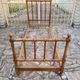 Child's bed or vintage rest bed made of solid cherry wood in a bamboo style.