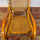 Antique rocking chair in curved wood and caning.