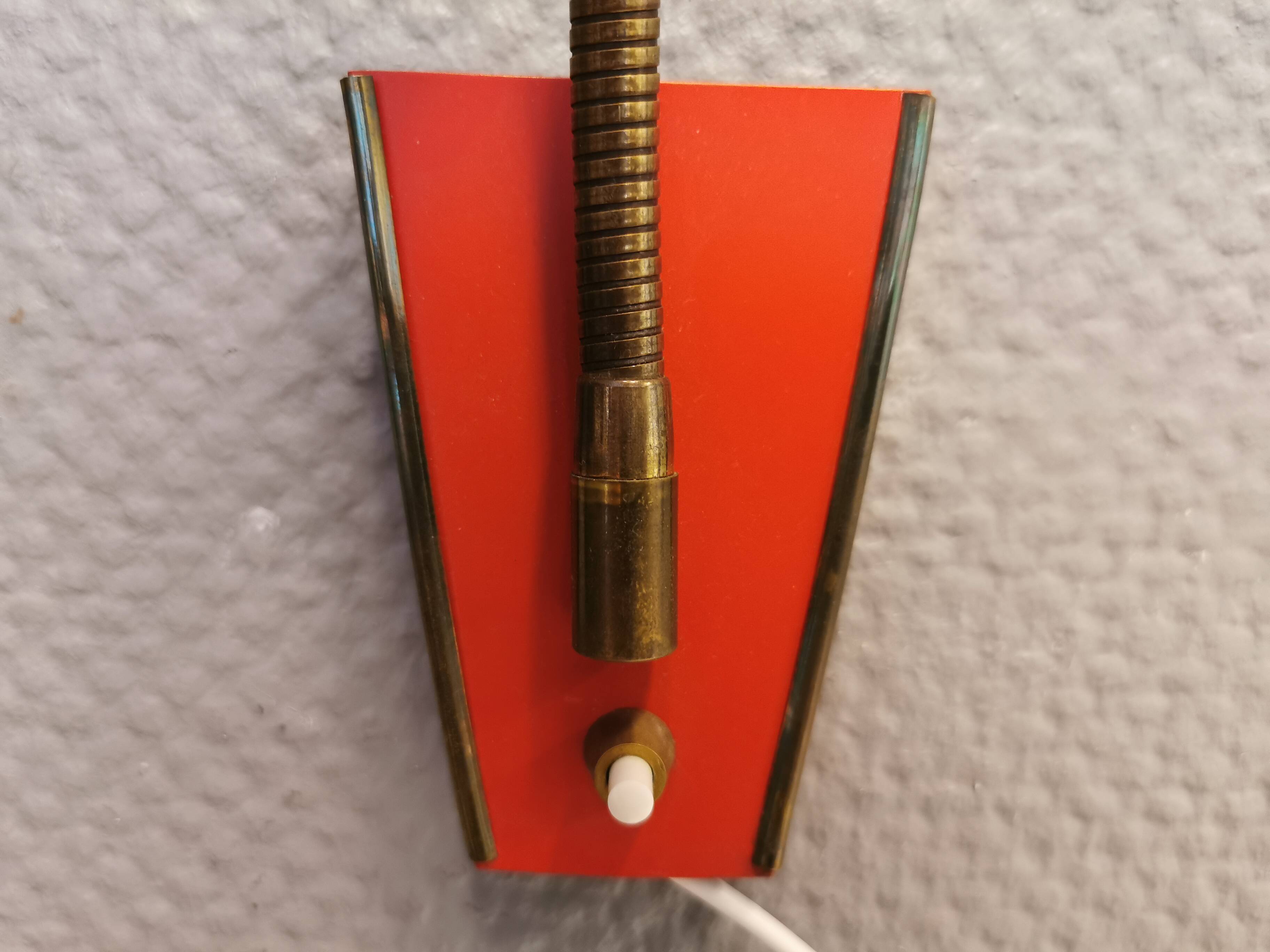 Danish red lacquered wall light with brass details. Estimated 1980s